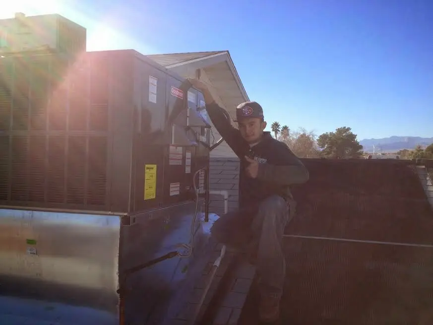 HVAC technician performing HVAC Inspection on a rooftop unit in Eau Claire